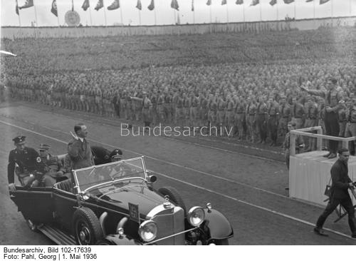 Adolf Hitler arriving to give a May Day address at Berlin's Poststadion, salutes the HJ formation
